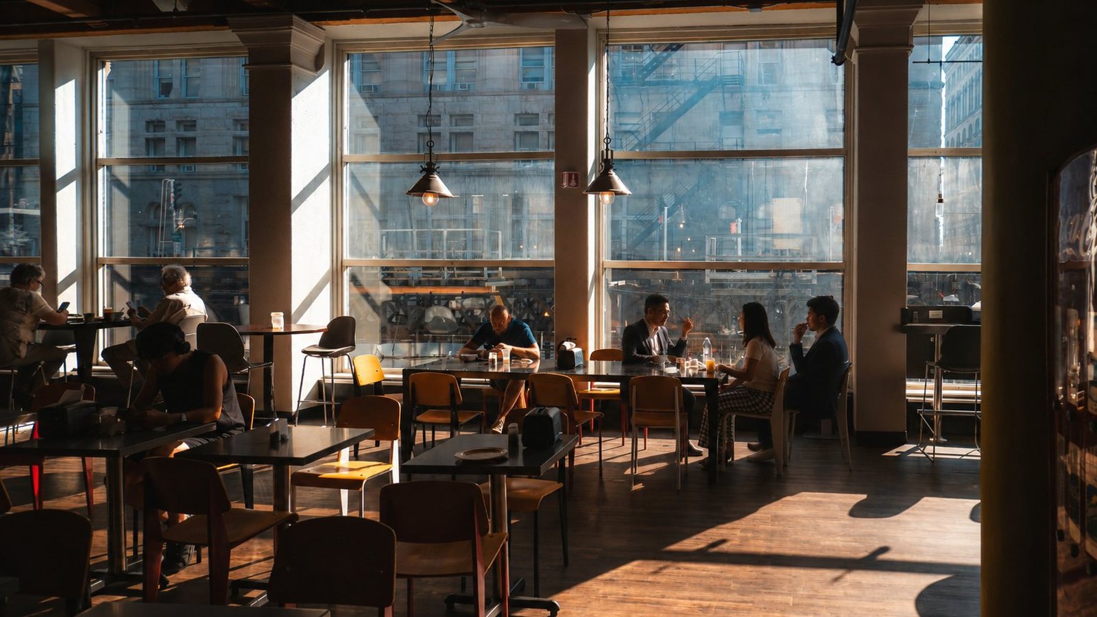 Clients in conversation at a sunlit cafe